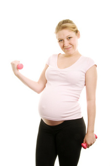 Photo of a pregnant client performing a fitness routine.