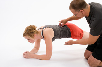 Photo of a core exercise specialist conducting core training on a client.