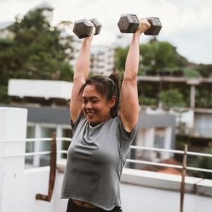 Image of a female client performing resistance training.